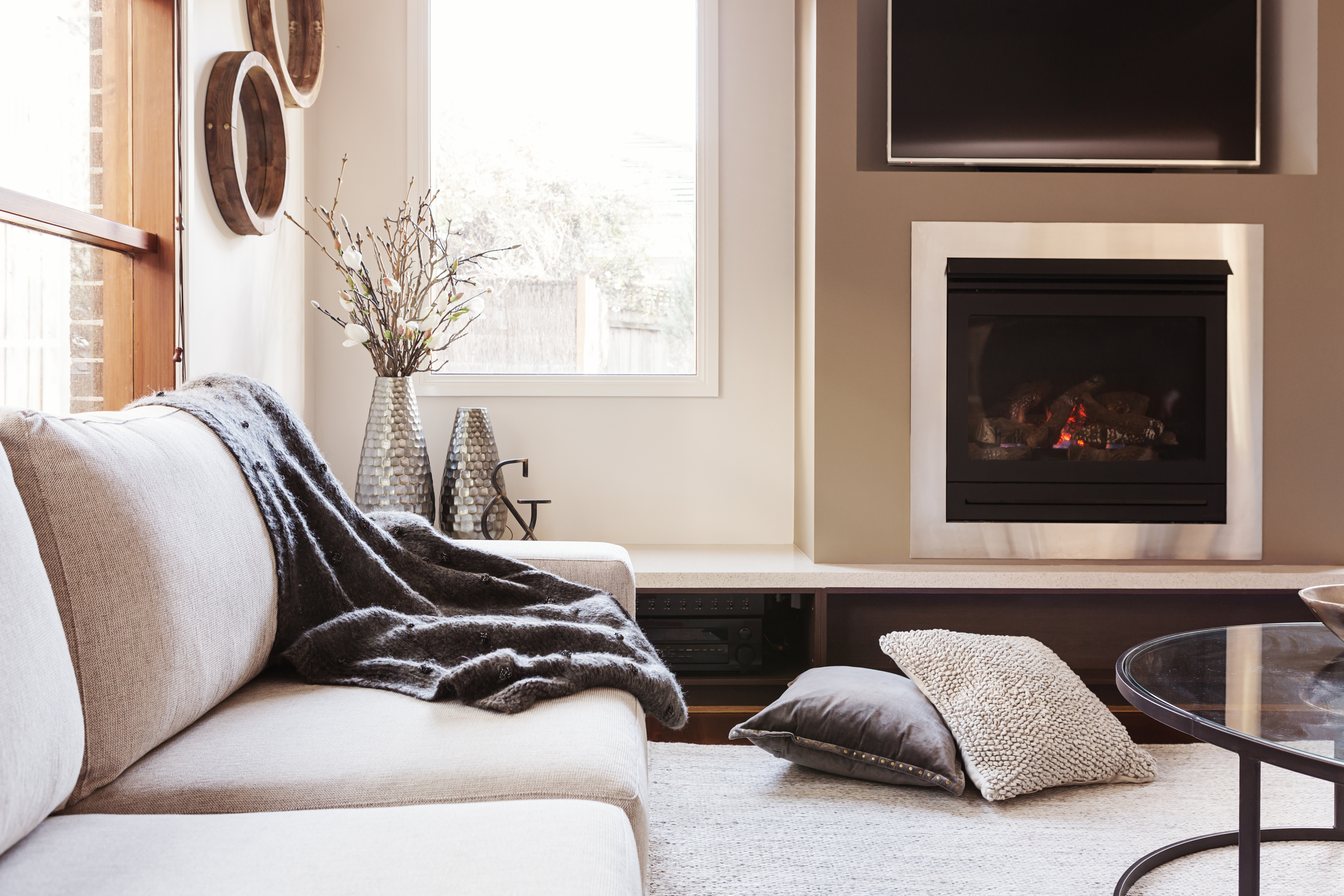 bright living room cosy sofa fireplace interior design