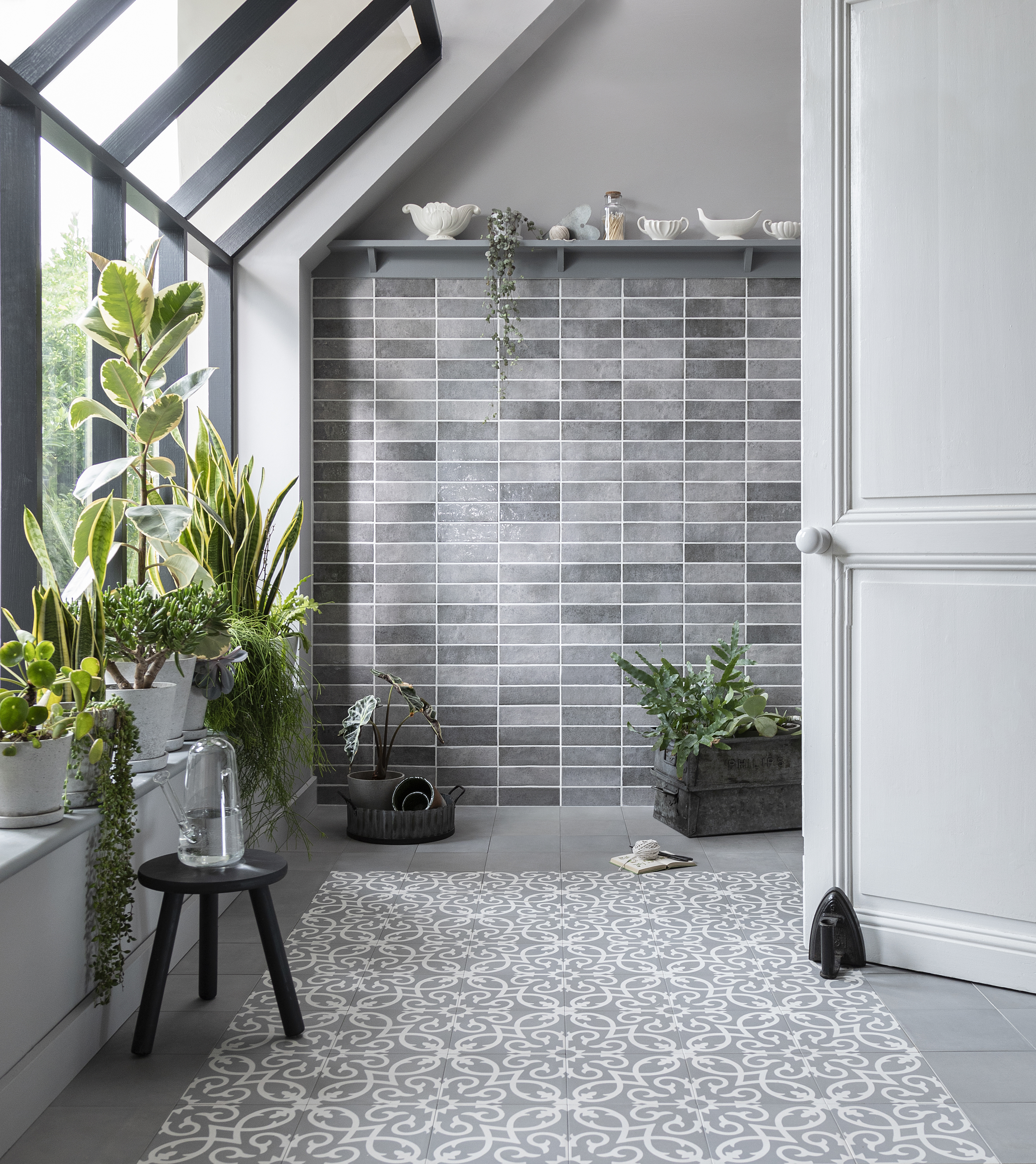beautiful luxury grey tiled bathroom with large windows