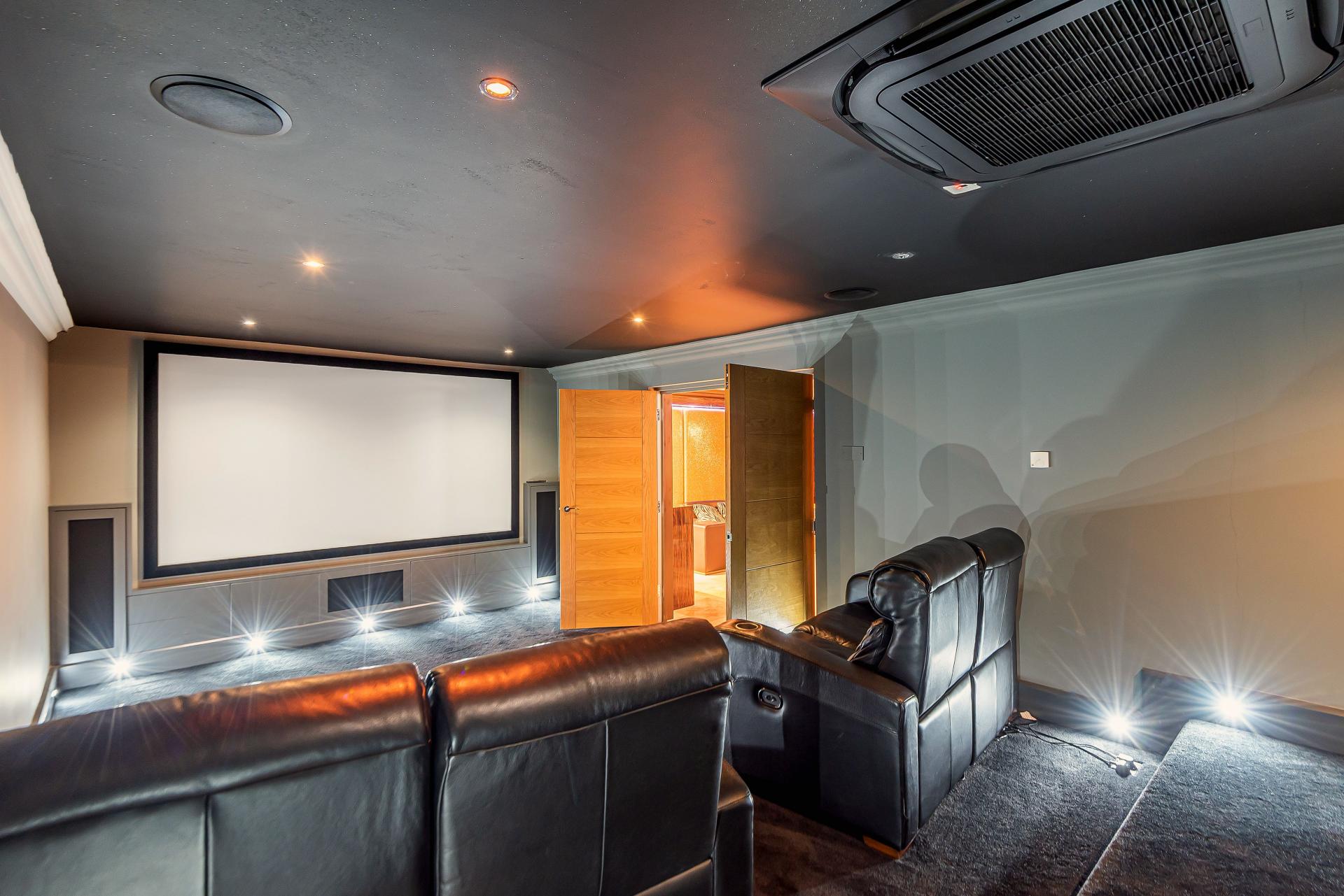 modern home cinema with lights and leather sofas
