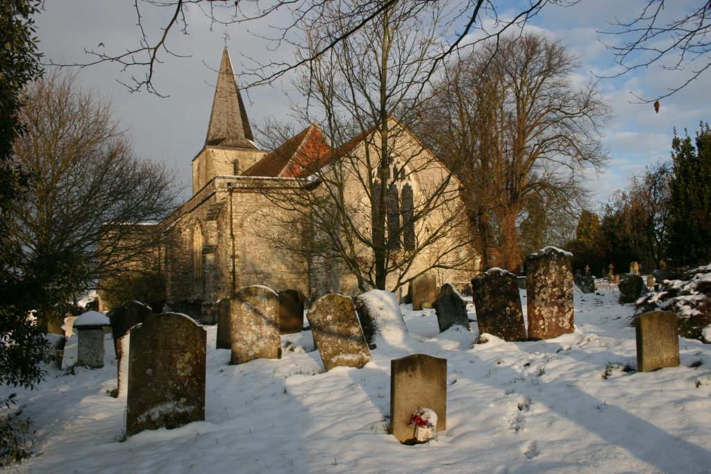 pluckley, kent spooky haunted church and graveyard in winter in the snow