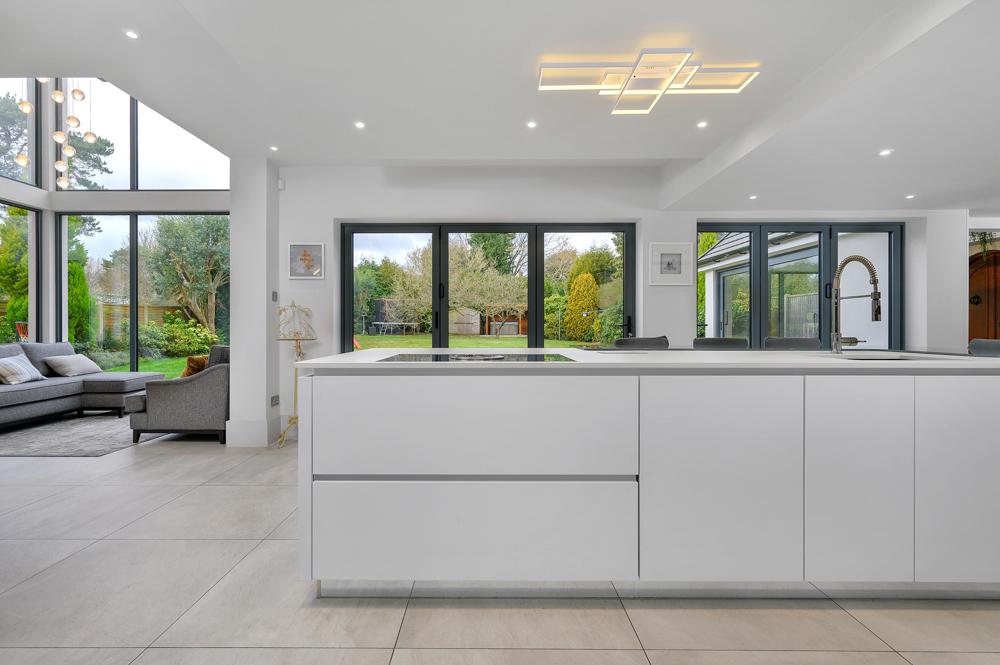 simple modern contemporary white kitchen island breakfast bar with garden Loughborough