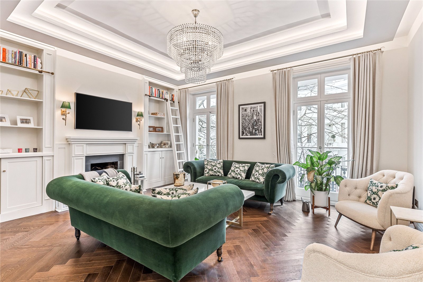 symmetrical living room with velvet green sofas and chandelier.jpg