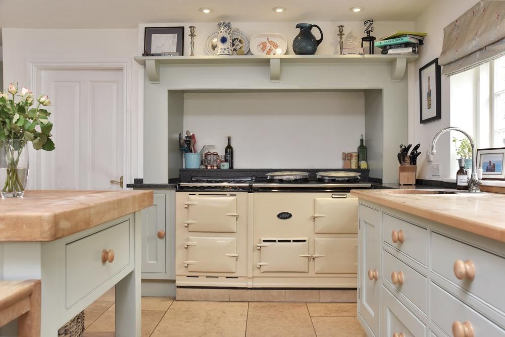 traditional large four door cream aga in english shaker kitchen putty paint wooden cabinets