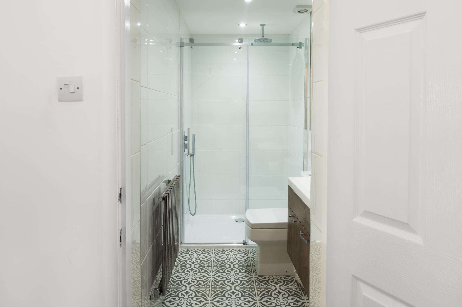 black and white patterned tiles in small bathroom