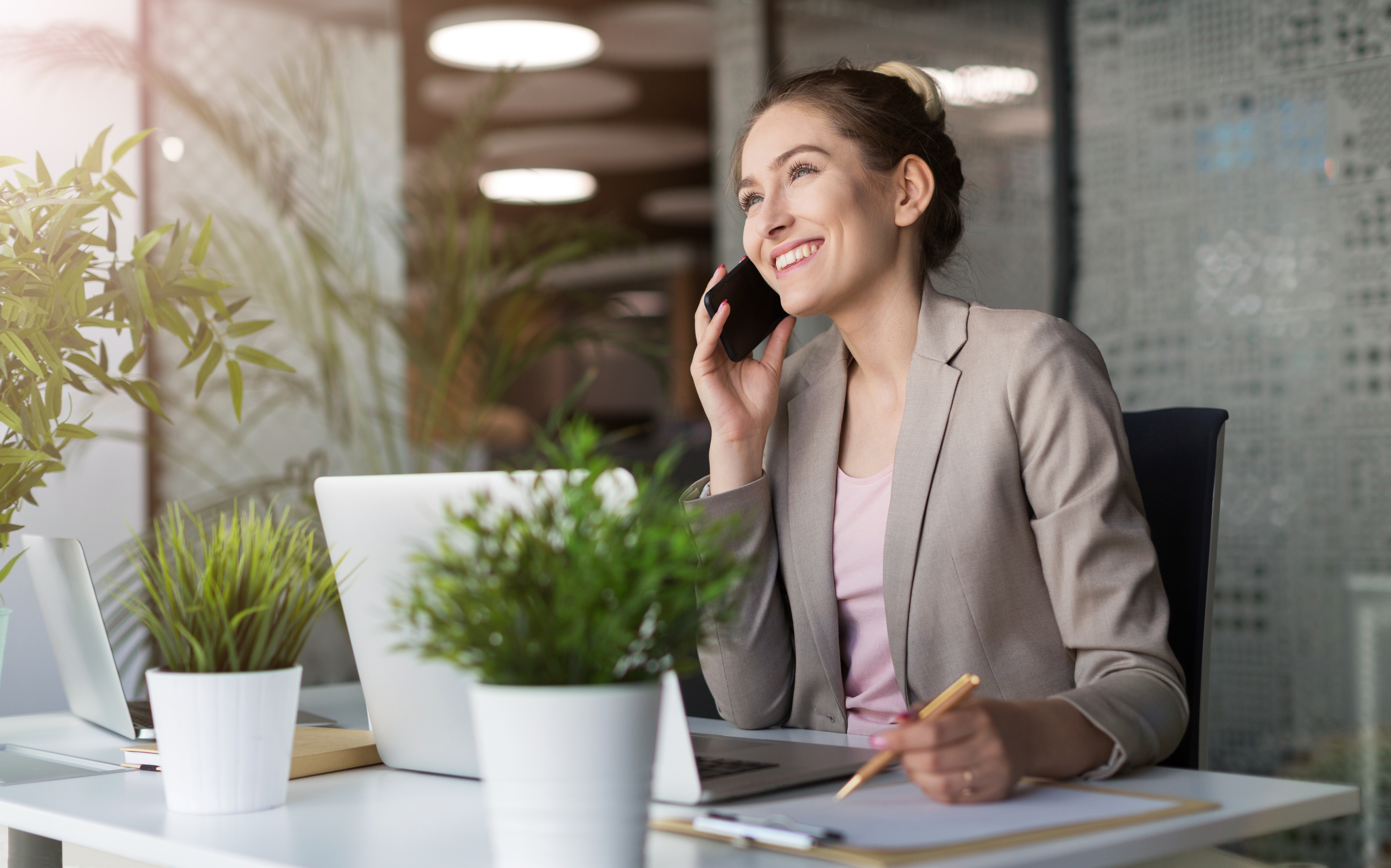 business woman in home office speaking on phone