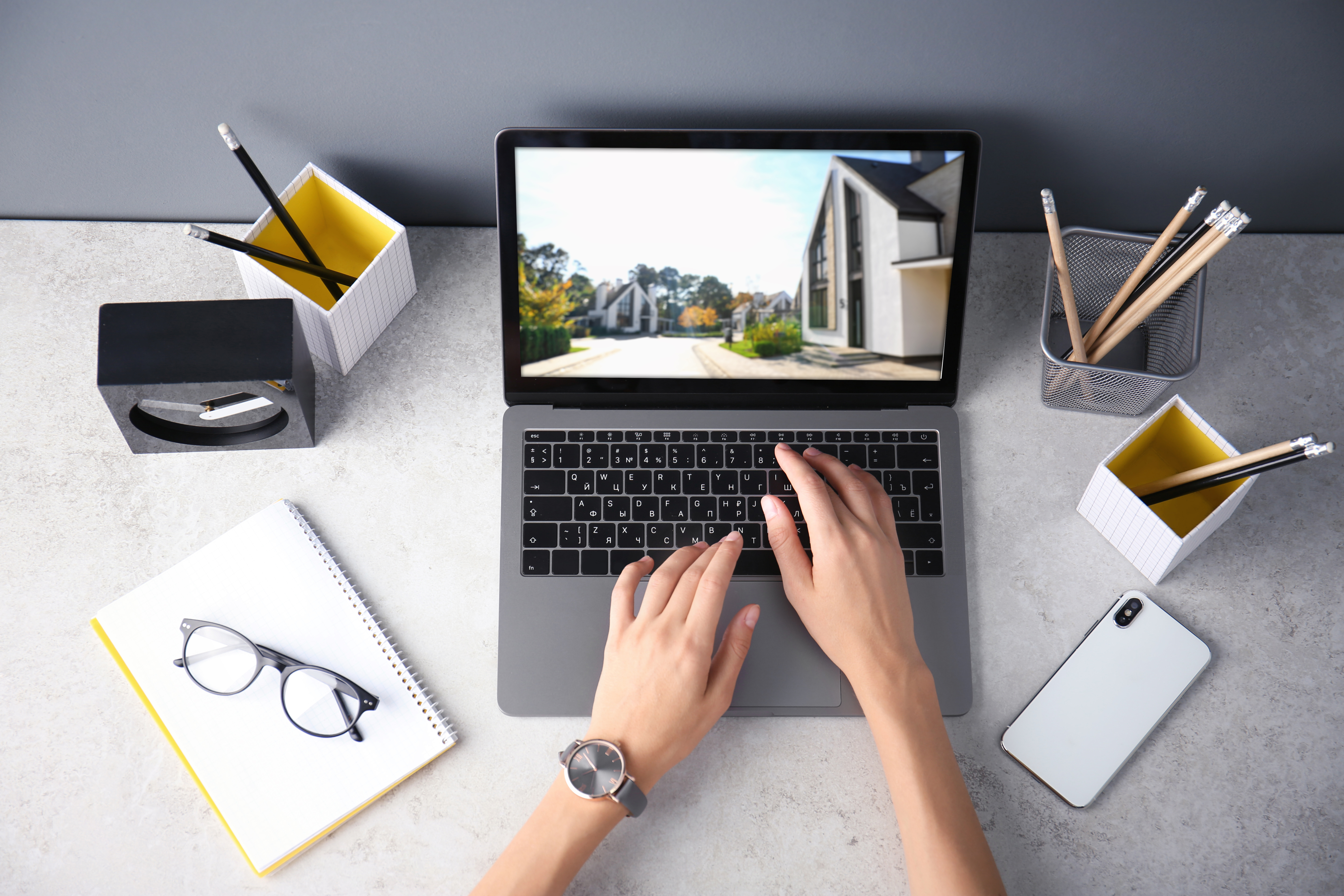 Businesswoman or real estate agent looking through online property portfolio, top view