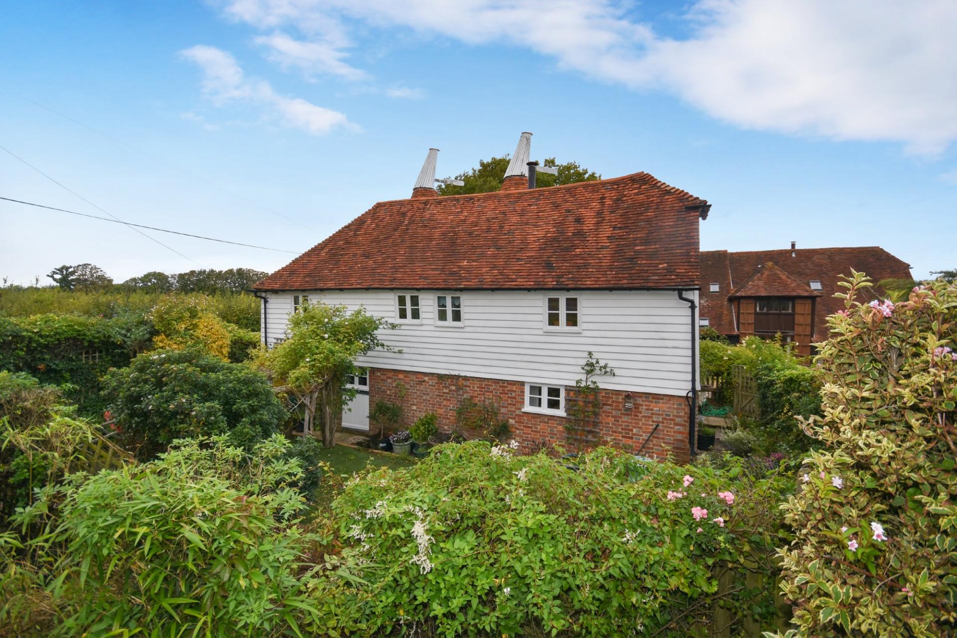 charming renovated converted oast house with white cladding