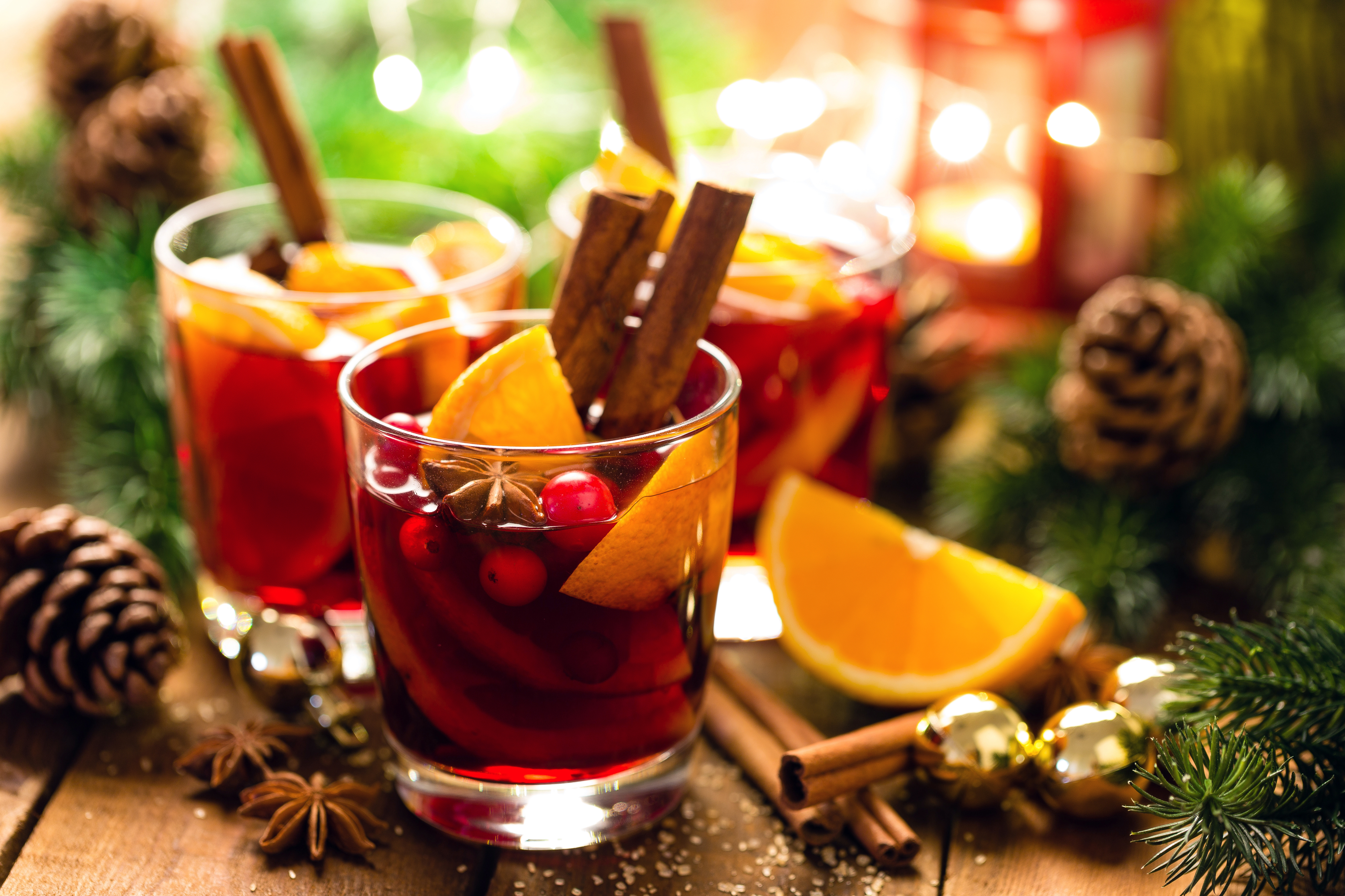 Christmas mulled red wine with spices and oranges on a wooden rustic table