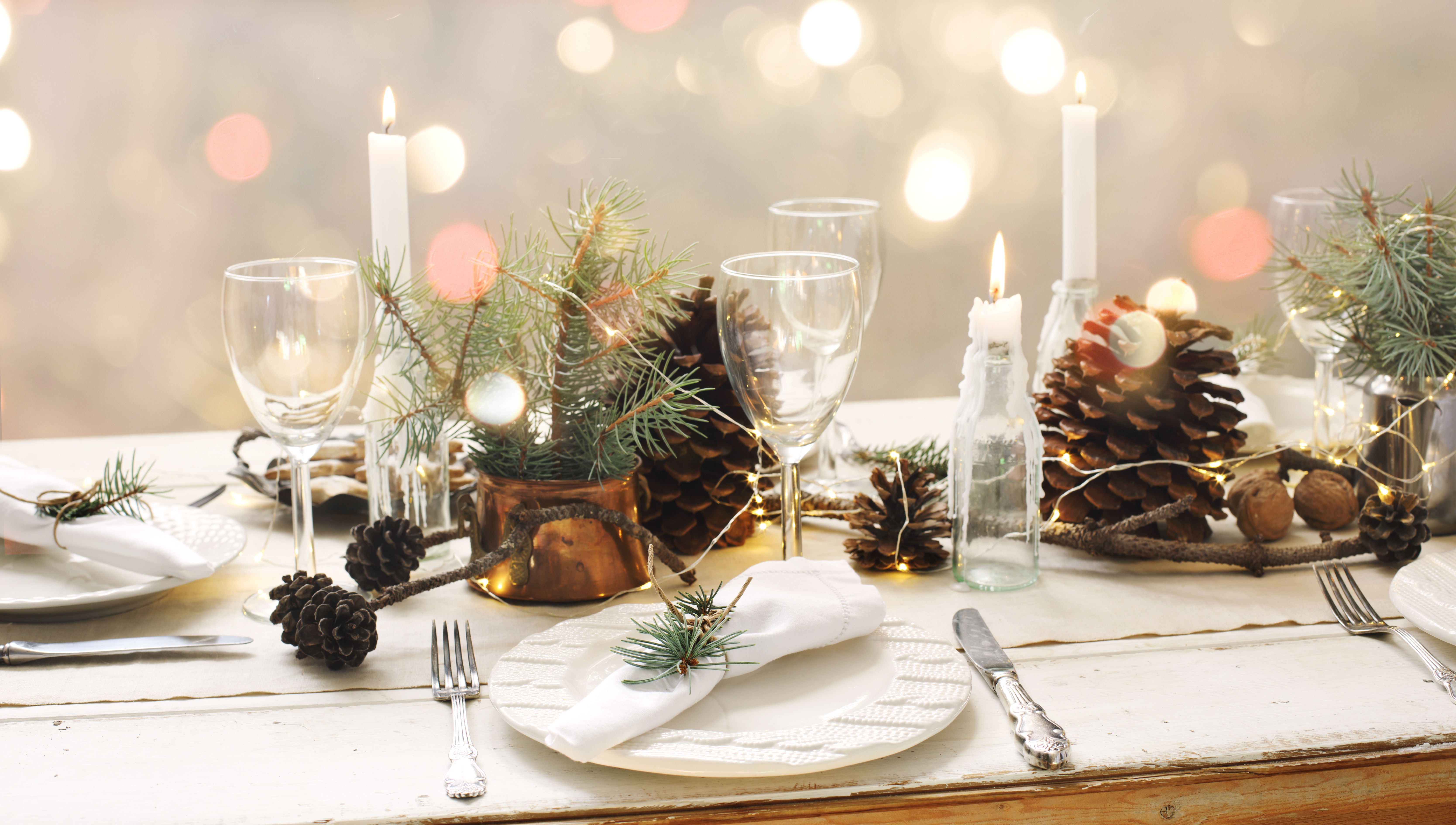 christmas dining table setting with fir tree and pine cone