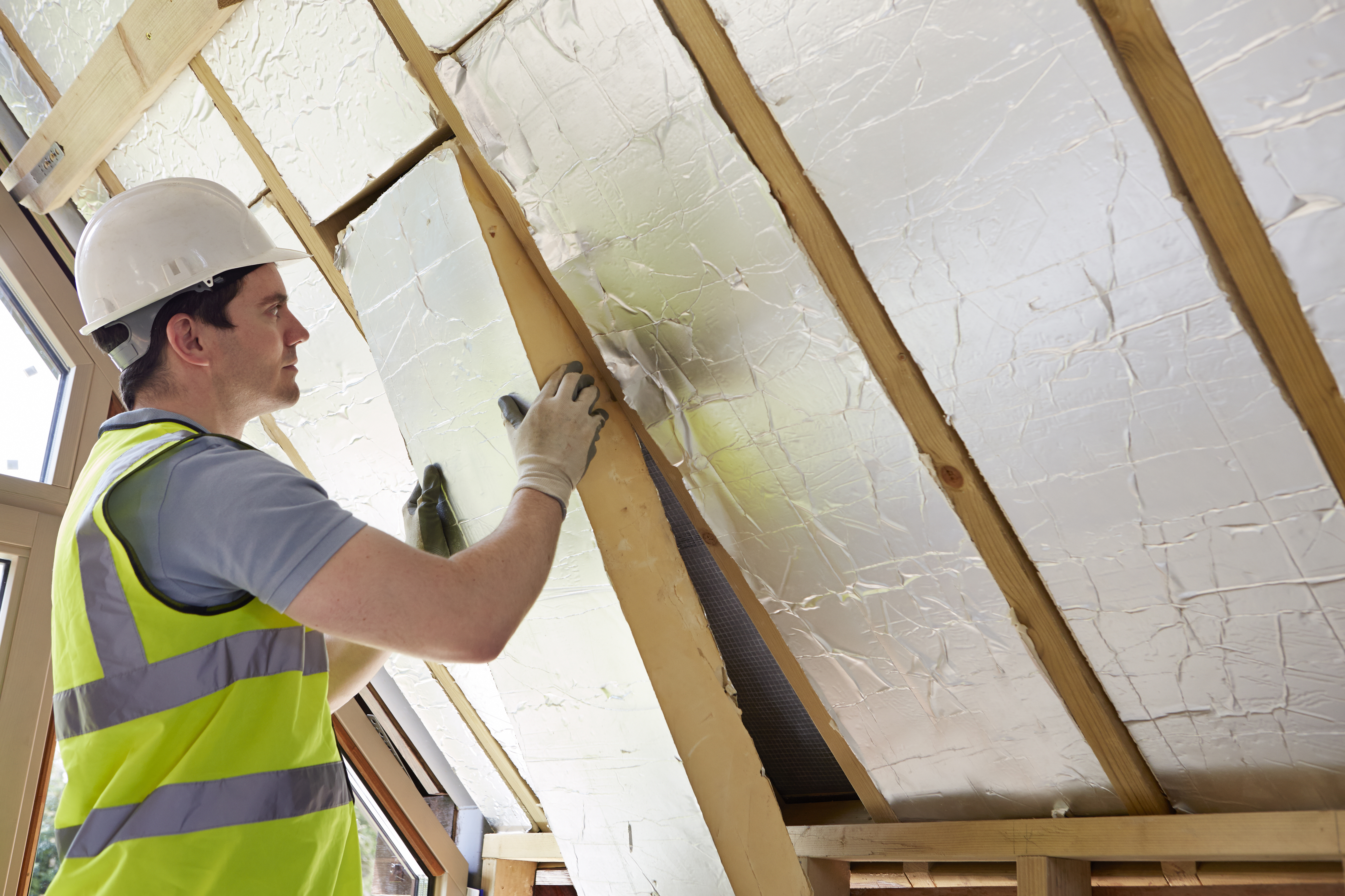 contractor installing insulation green homes grant