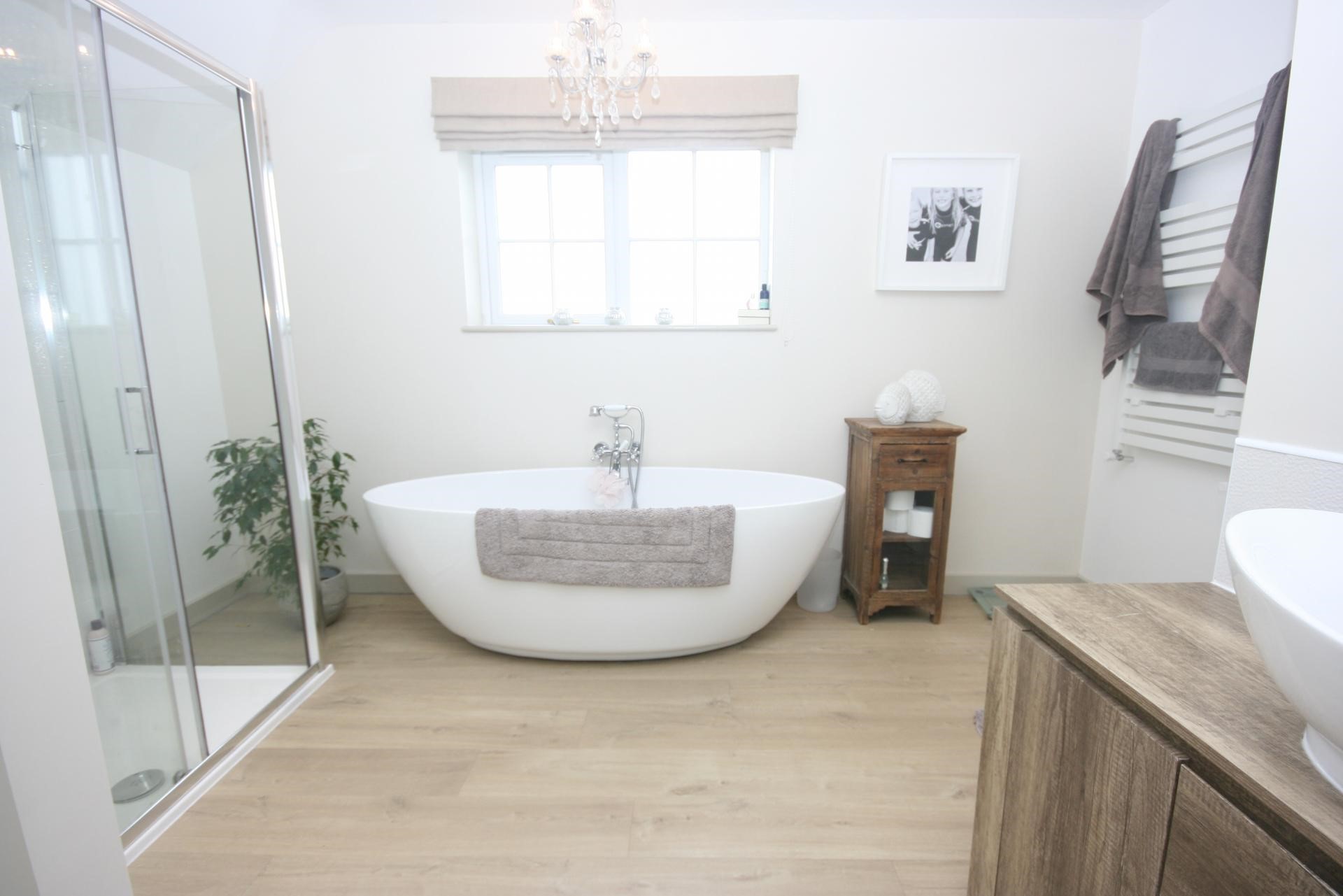 elegant chic interior design neutral bathroom with freestanding bathtub