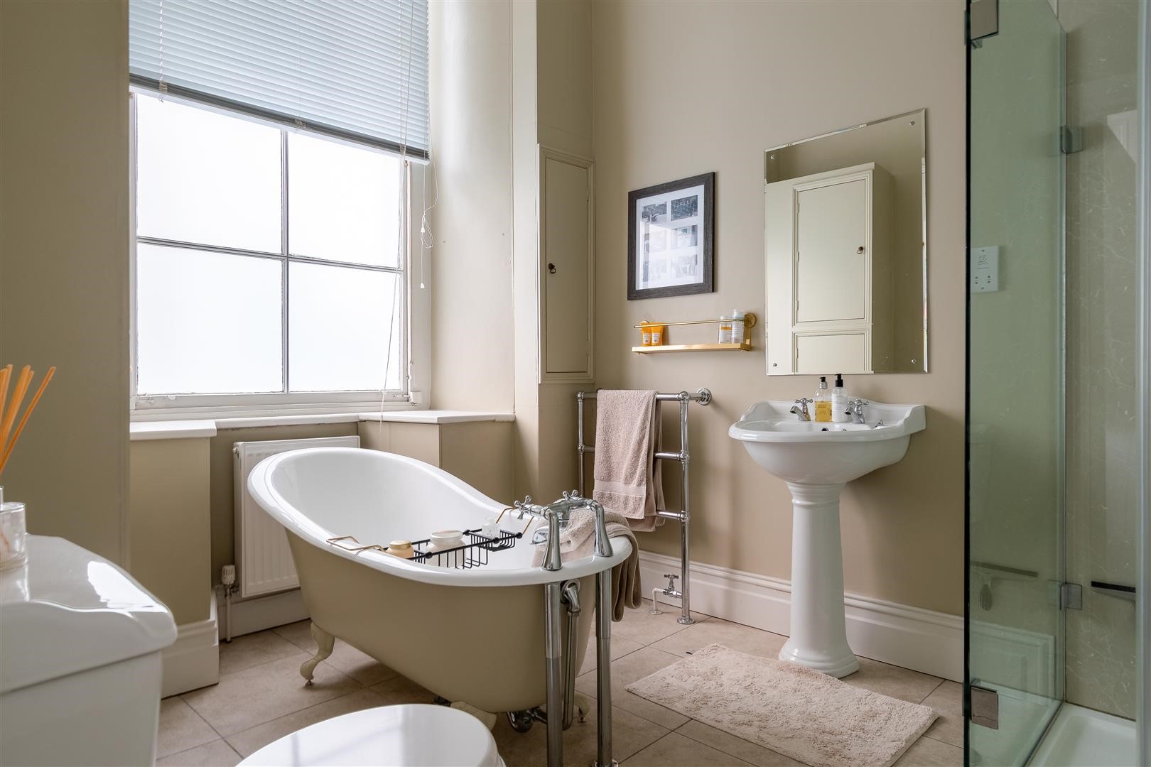 elegant townhouse neutral bathroom with freestanding bathtub