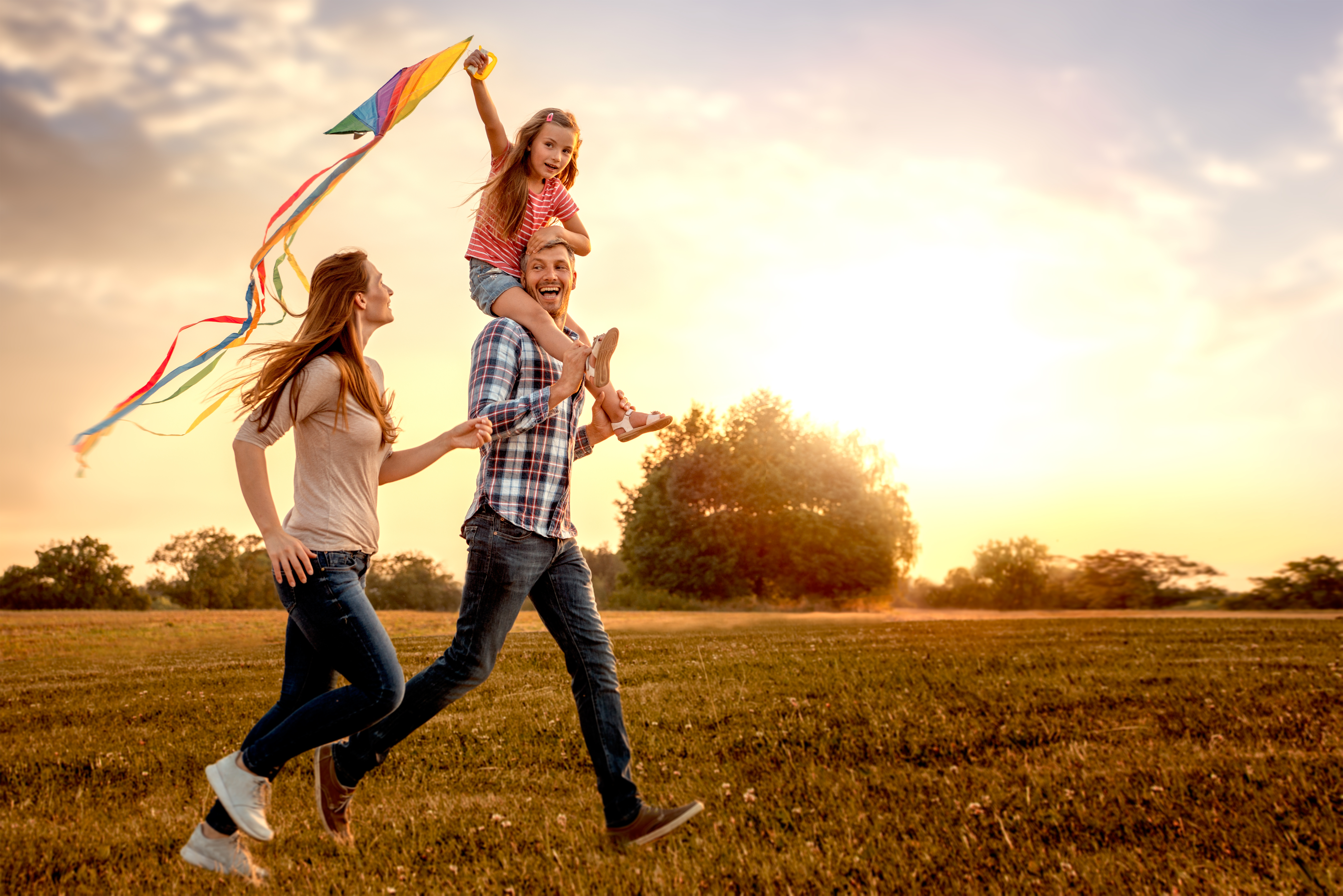 family_exercising_flying_kite_in_park