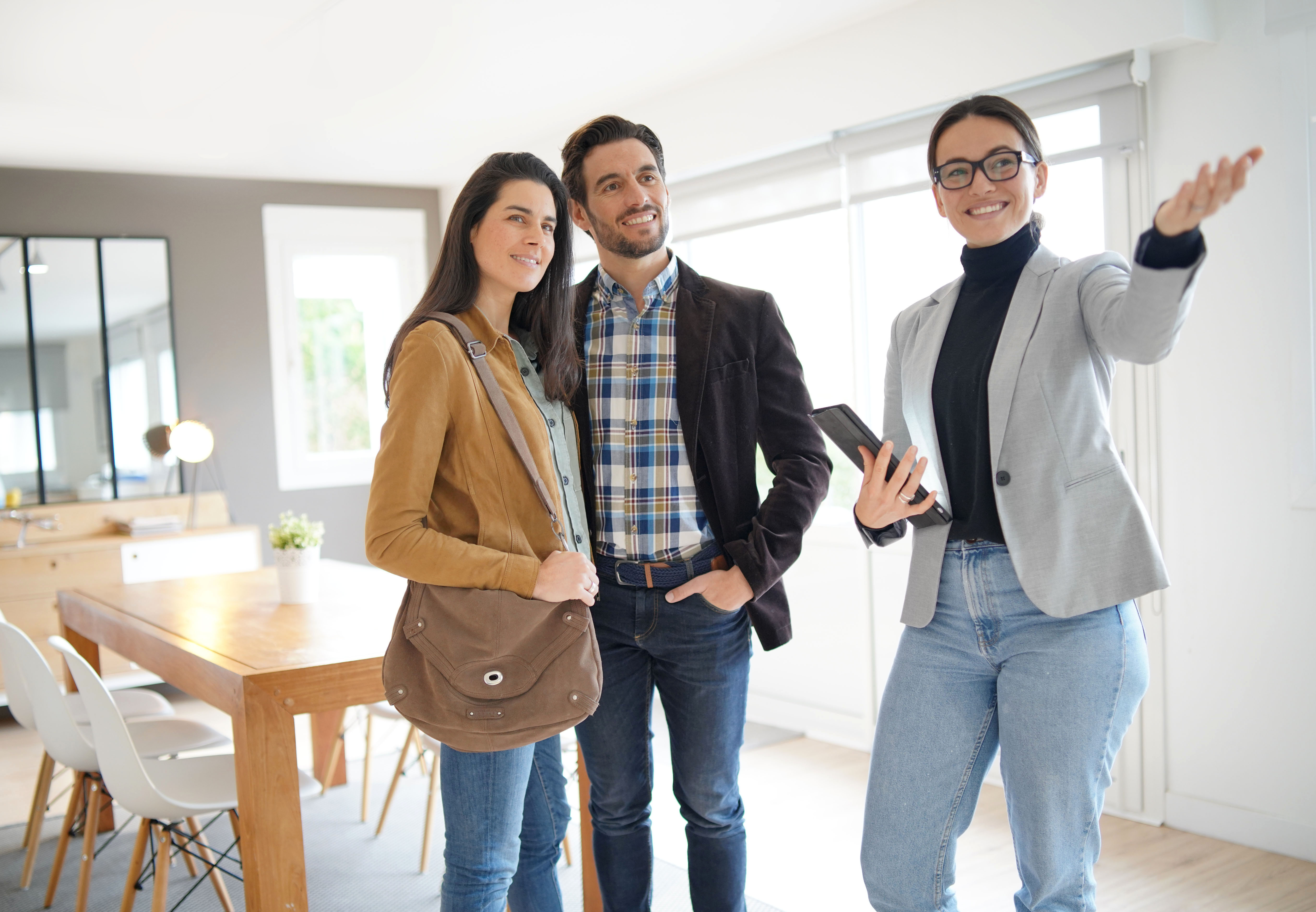 happy young couple house viewing estate agent