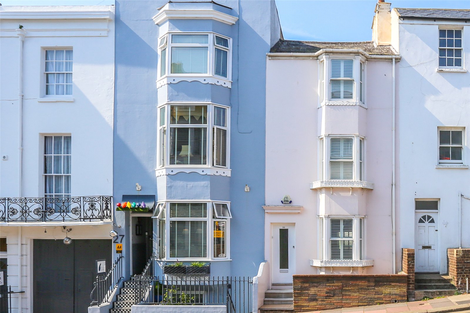 pretty purple and pink colourful terraced houses on south coast in brighton