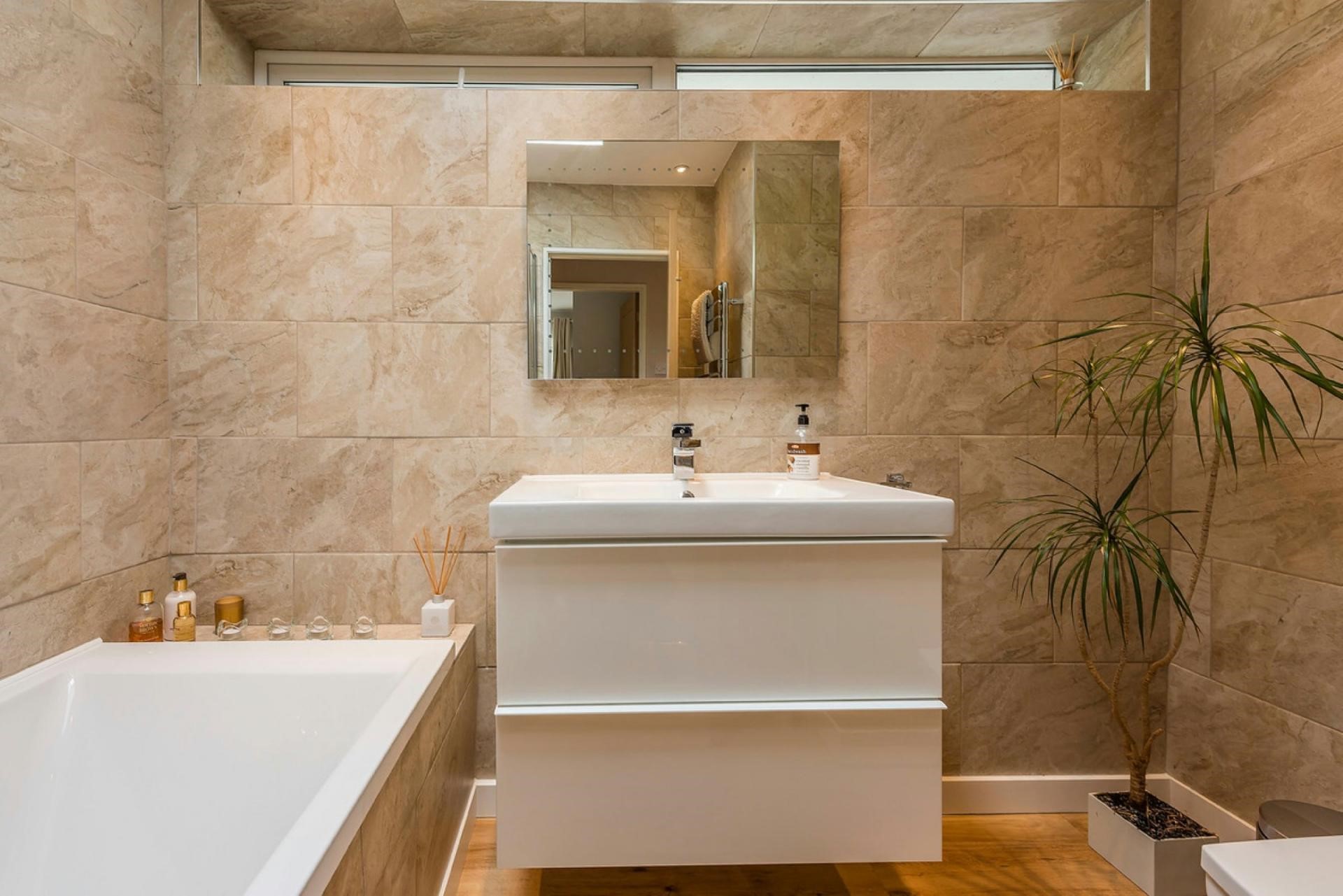 spa inspired bathroom with neutral natural wall tiles freestanding vanity basin