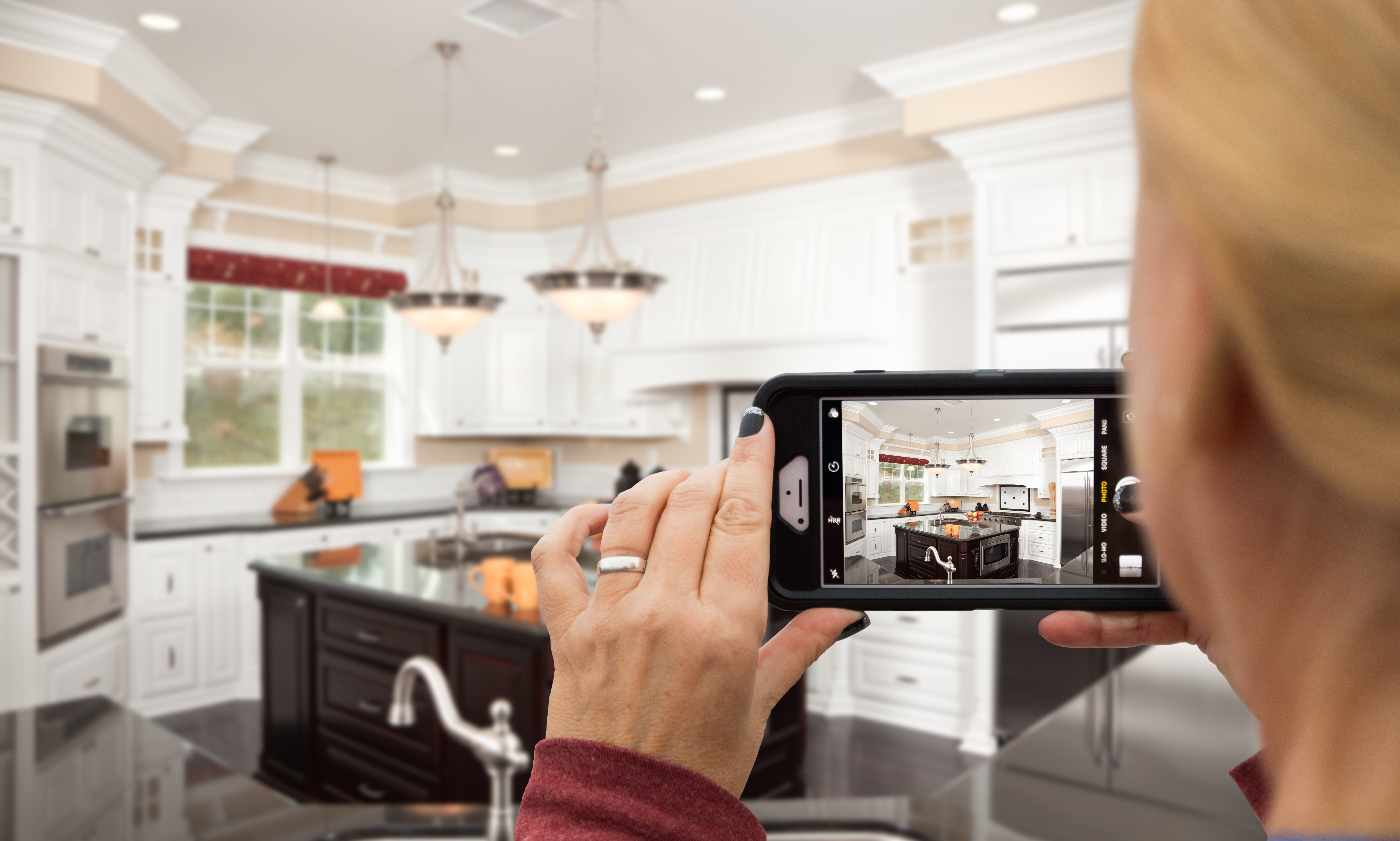 woman taking photo video of her kitchen house