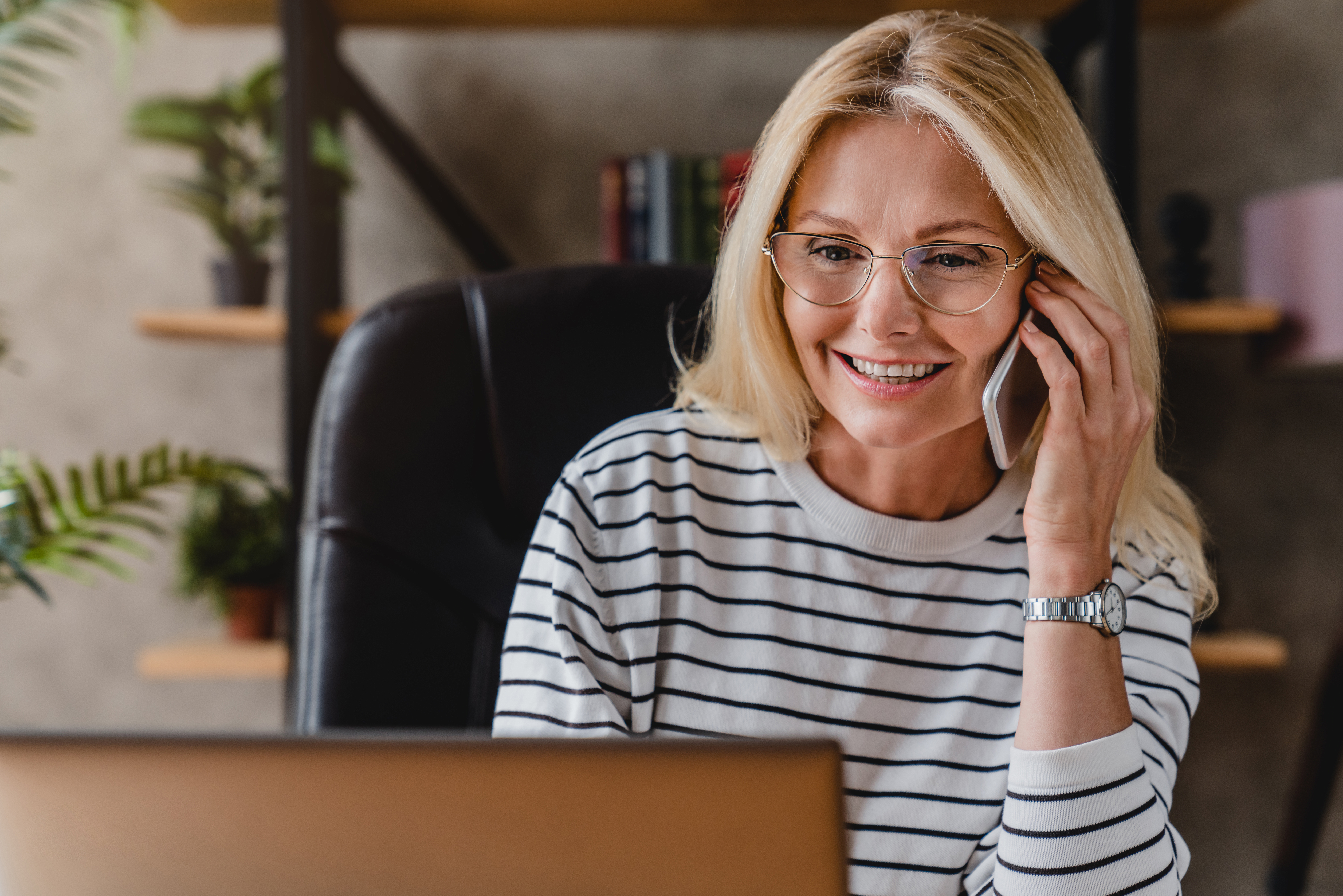 friendly woman on phone in home office