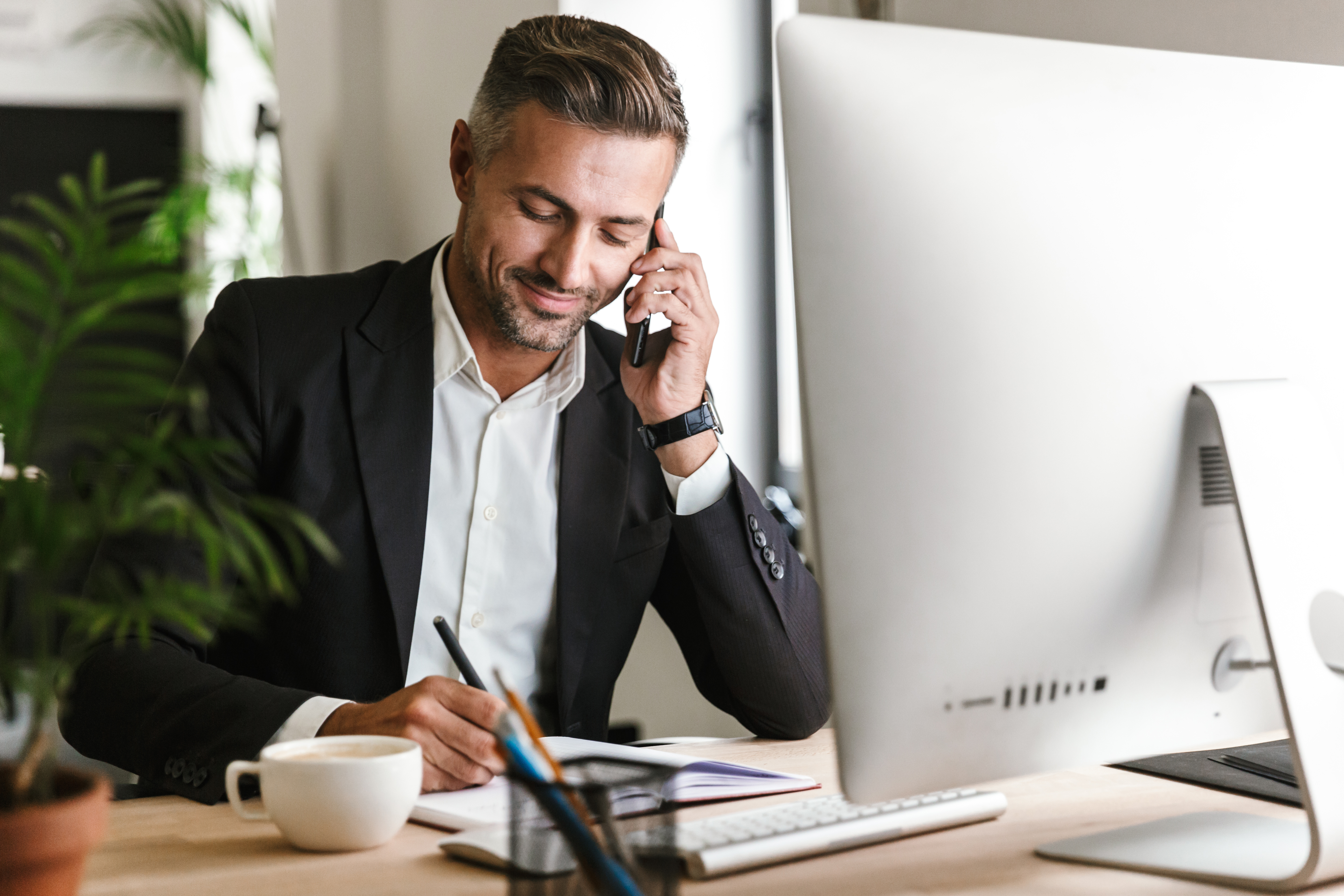 handsome businessman talking on phone in office