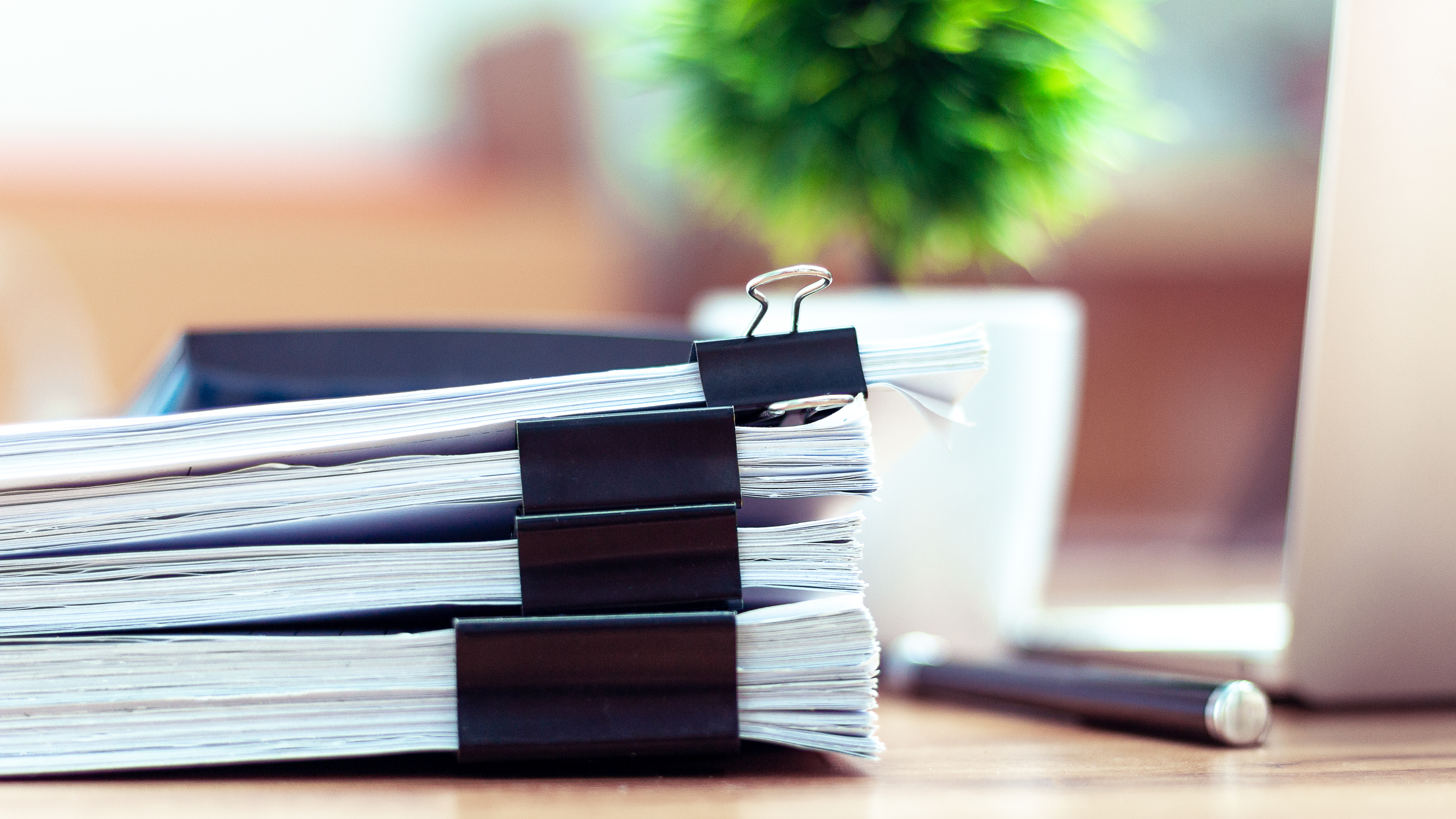 Stack of documents placed on a business desk in a business office.