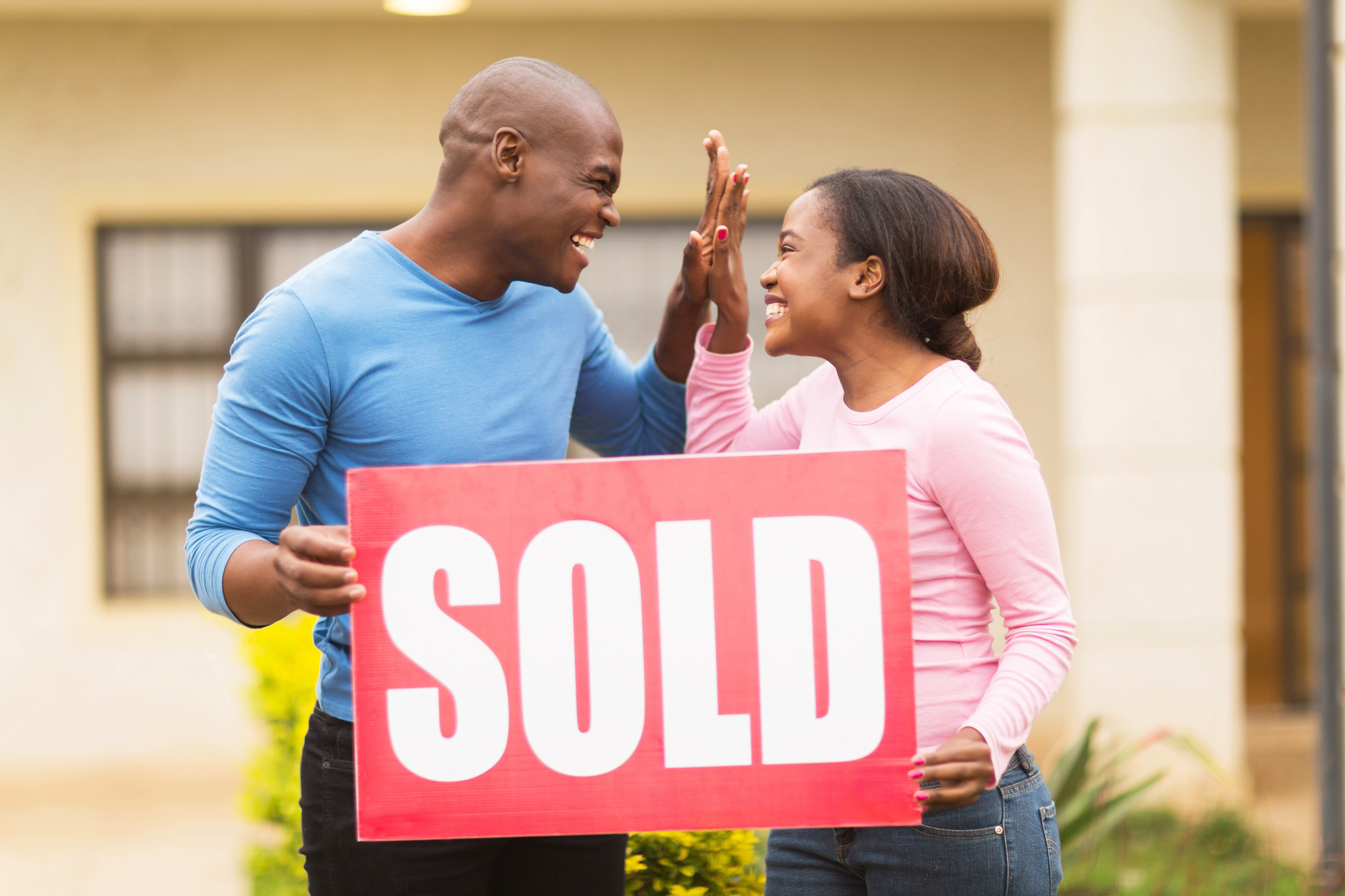  couple celebrating their house been sold