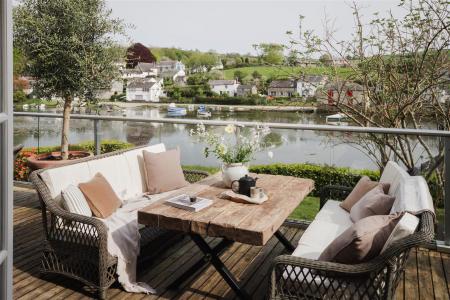 br-26 looking out doors to coffee table and river