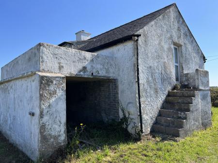 Side with former garage and balcony over