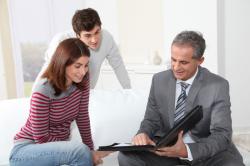 young couple going through house sale paperwork with their Williamsons estate agent