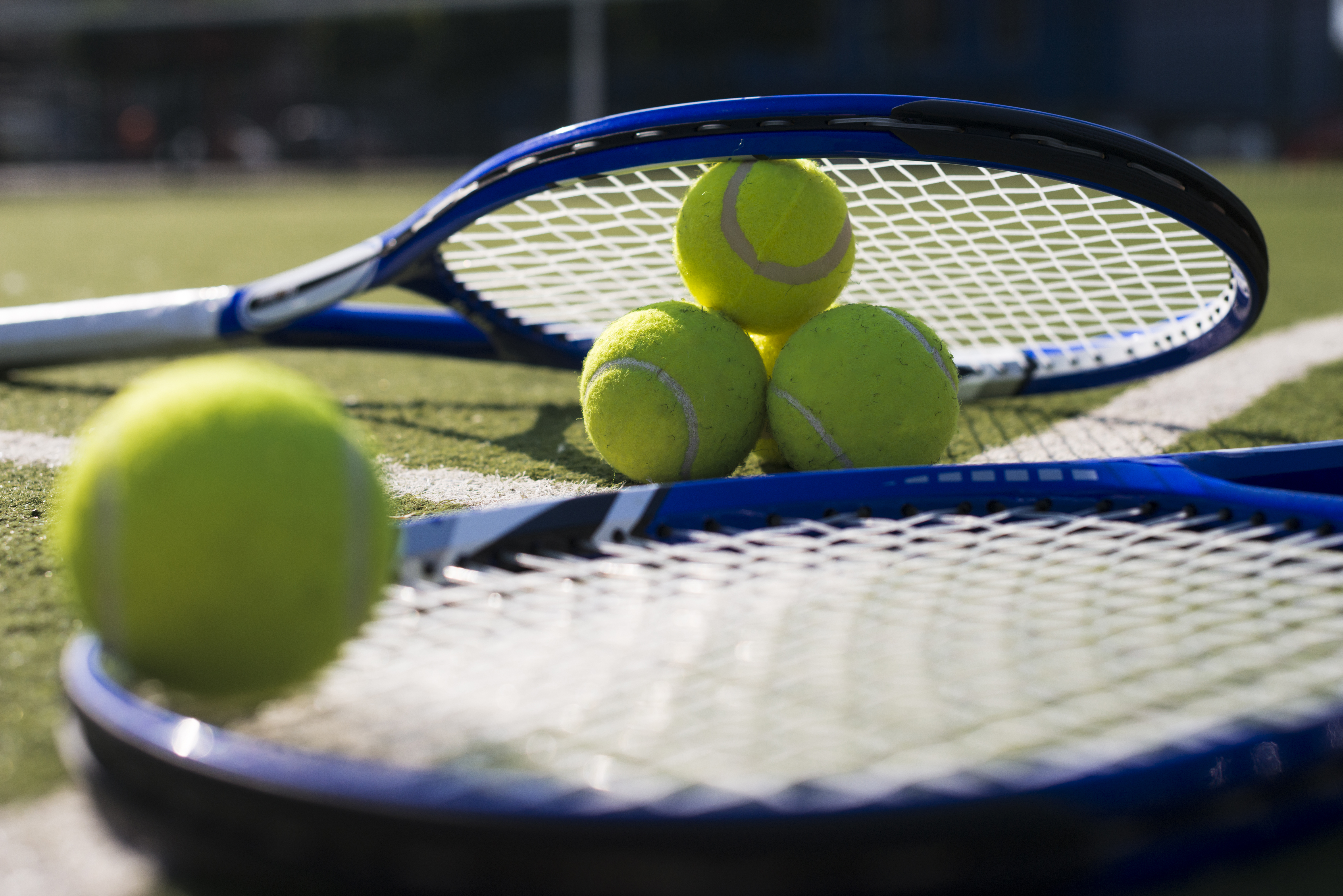 close-up-tennis-rackets-balls